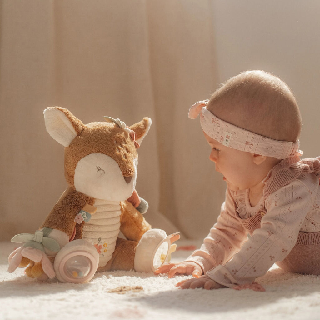 Baby holding the Little Dutch Fairy Garden activity deer
