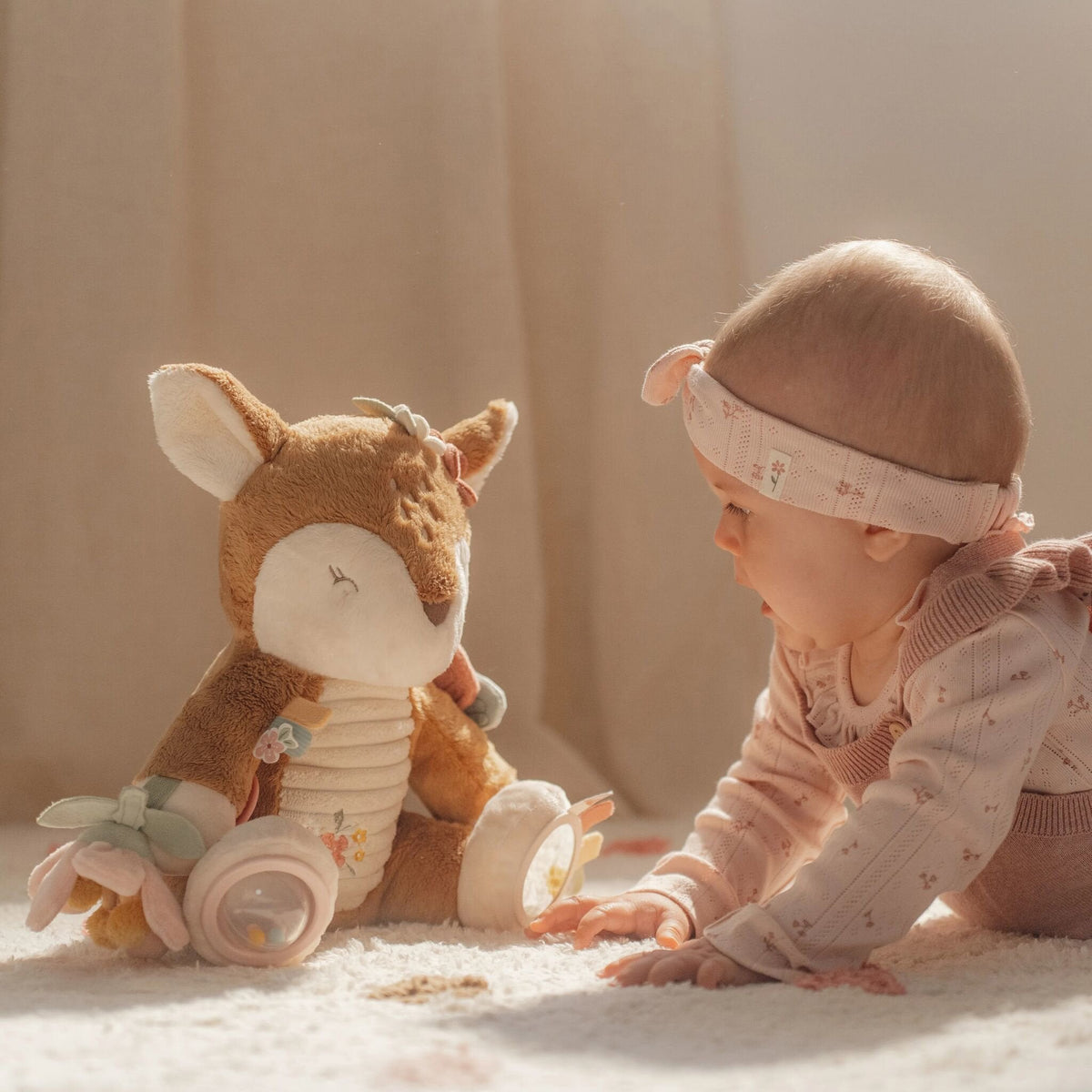 Baby holding the Little Dutch Fairy Garden activity deer