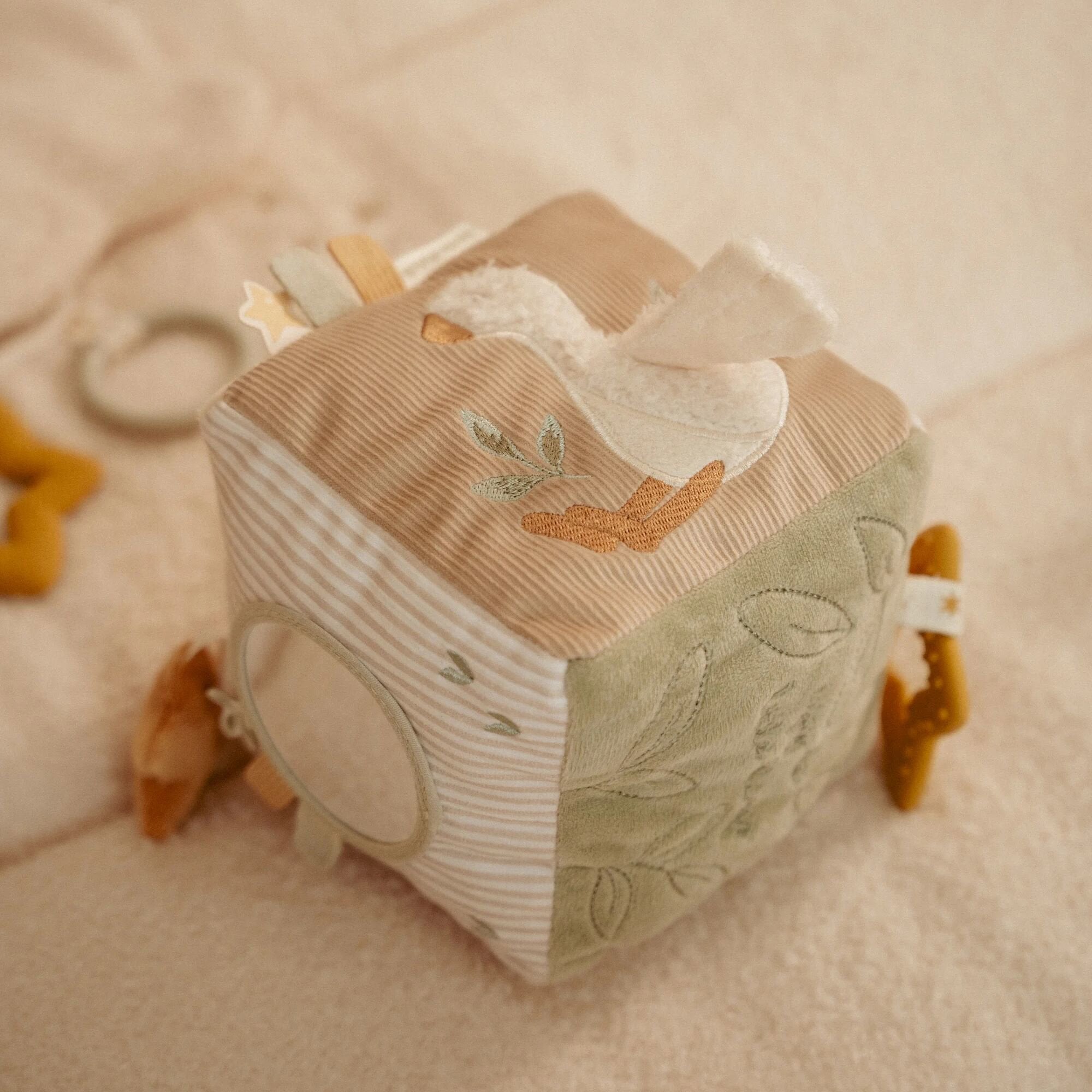 Little Dutch Activity Cube Newborn Naturals held in baby hands