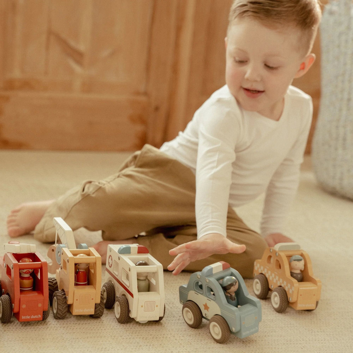 Child playing with the Little Dutch wooden taxi
