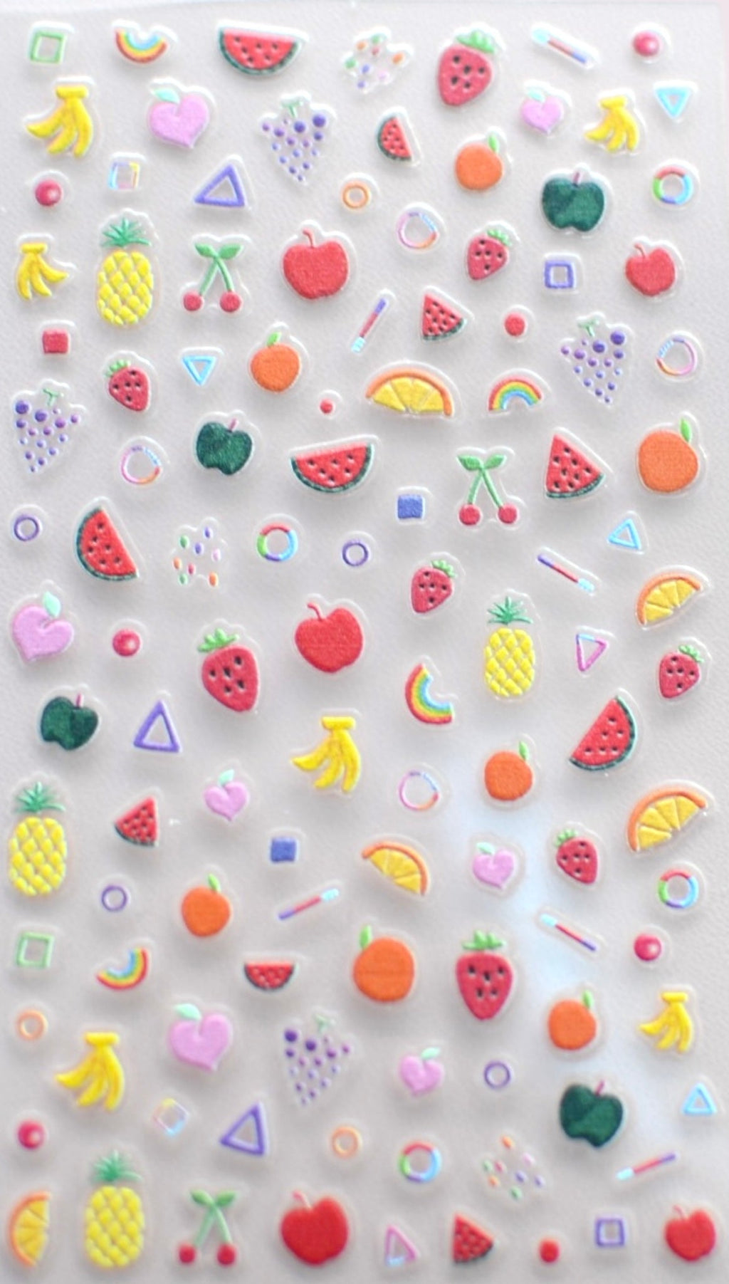 Fruit nail stickers applied to a child's nails