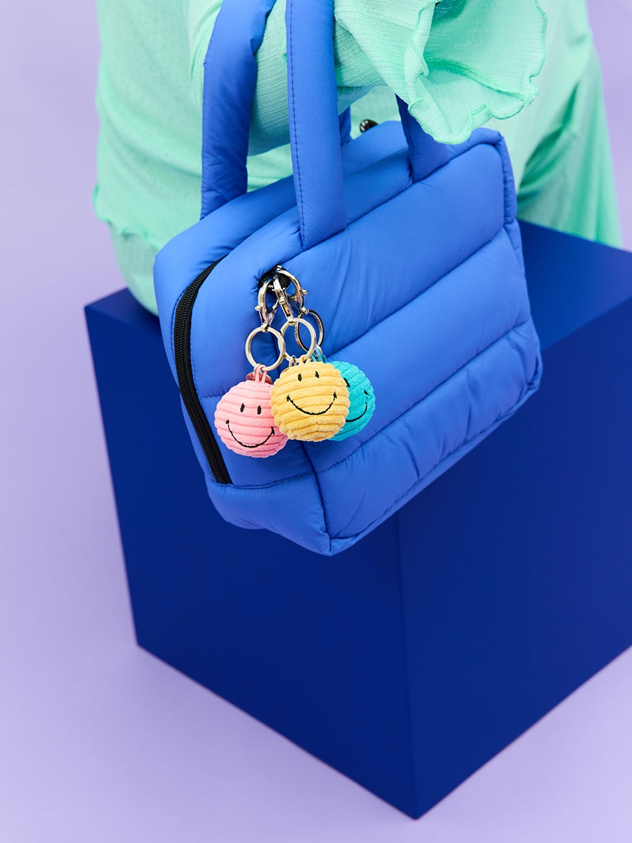 Bon Ton Toys x Smiley Corduroy Keychains on a bag