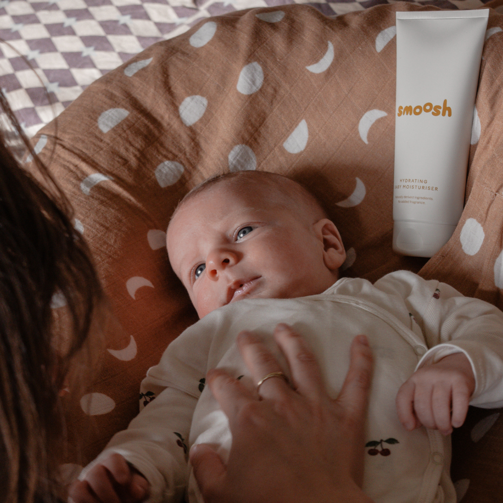 Parent moisturising a baby with Smoosh hydrating baby moisturiser