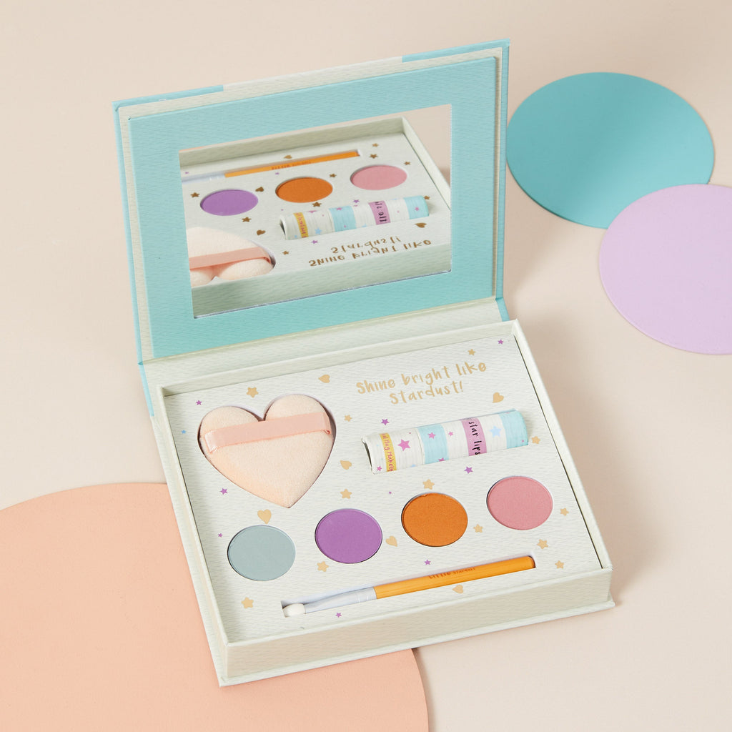 Open children's play makeup kit tin showing four pressed mineral shades