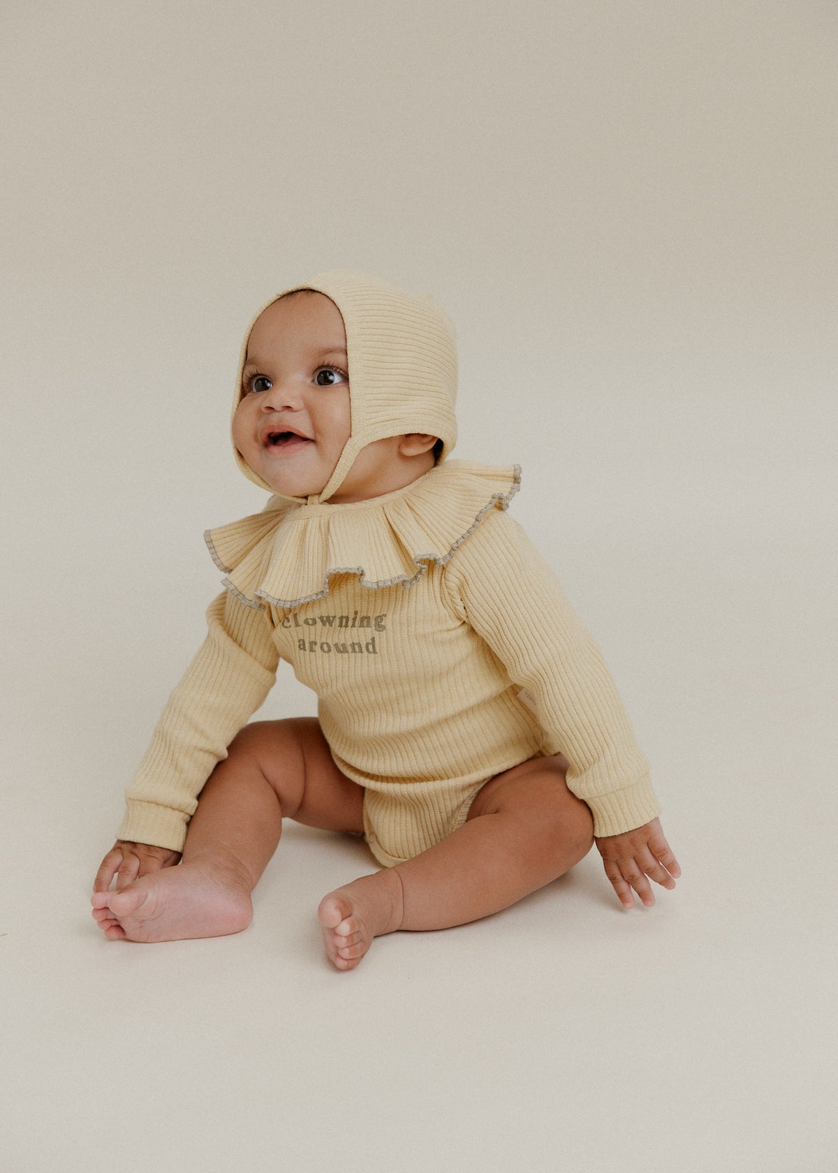 Claude & Co Clowning Around yellow ribbed baby bodysuit with frilled collar